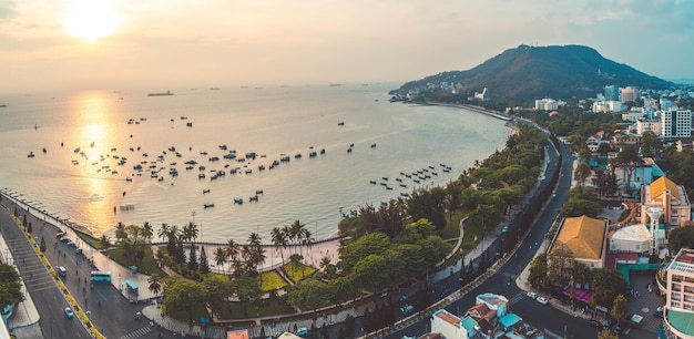 Panoramic coastal Vung Tau view from above with waves coastline streets coconut trees mountain