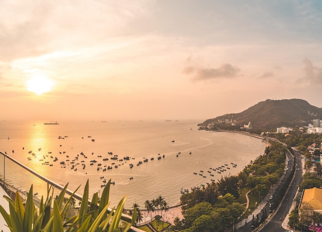 Panoramic coastal Vung Tau view from above with waves coastline streets coconut trees mountain