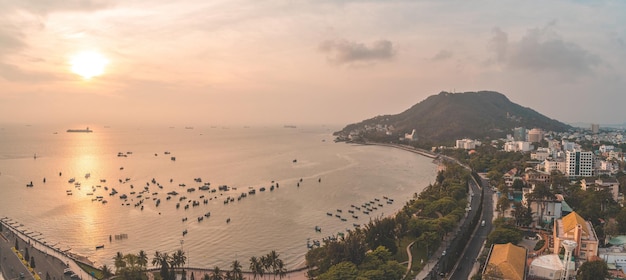 Panoramic coastal Vung Tau view from above with waves coastline streets coconut trees mountain