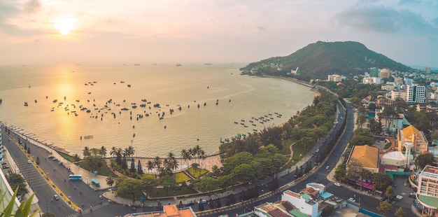 Panoramic coastal Vung Tau view from above with waves coastline streets coconut trees mountain