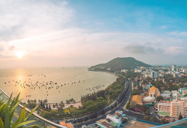 Panoramic coastal Vung Tau view from above with waves coastline streets coconut trees mountain