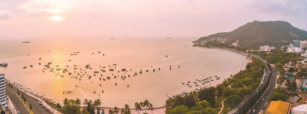 Panoramic coastal Vung Tau view from above with waves coastline streets coconut trees mountain