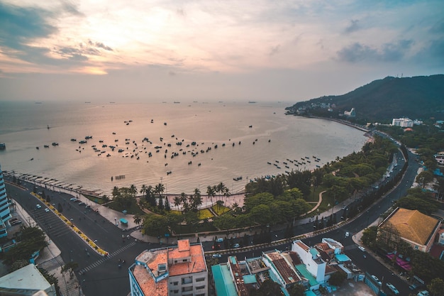 Panoramic coastal Vung Tau view from above with waves coastline streets coconut trees mountain