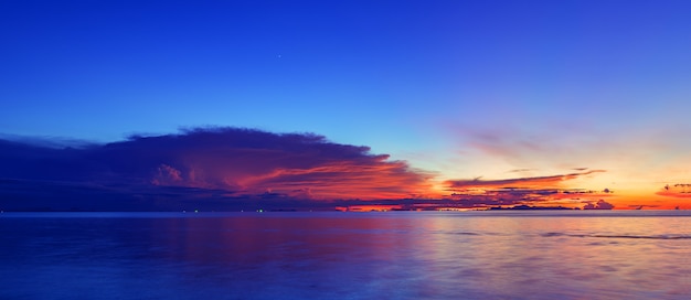 Panoramic dramatic blue sea sky sunset with golden light background