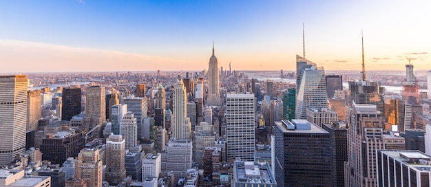 Panoramic photo of New York City Skyline in Manhattan downtown with skyscrapers at sunset USA