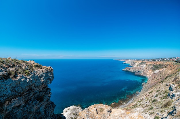 Panoramic seascape calm azure sea and bright sun view of the black sea coast in crimea cape fiolent