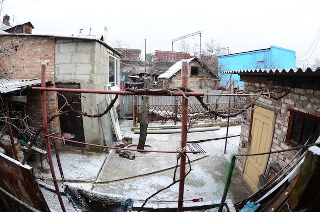 Panoramic shot of the old Ukrainian courtyard with a house and a barn. 