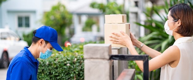 Panoramic side view asian woman with face mask customer take shopping packages contactless