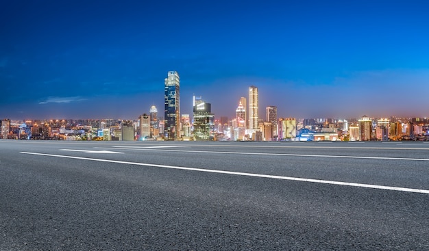 Panoramic skyline and empty asphalt road with modern buildings