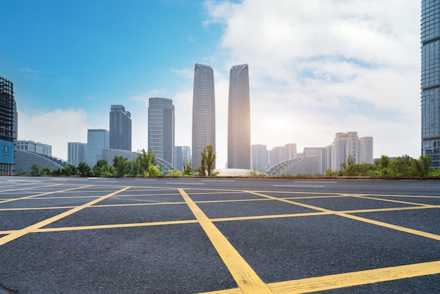 Panoramic skyline and empty asphalt road with modern buildings