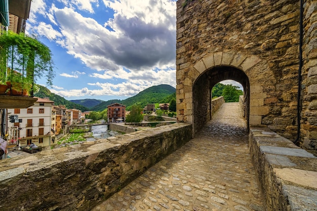 Panoramic stone bridge and arch to cross it in the picturesque town of Camprodon Girona Catalonia