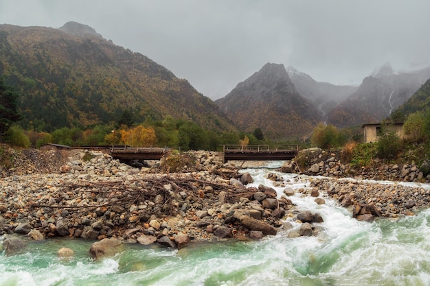 Panoramic view of amazing mountain stormy Khares River in North Ossetia Awesome highland scenery with beautiful glacial streams among rainy hills and rocks Caucasus Mountains