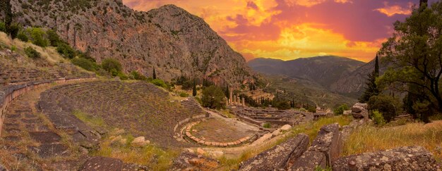 Panoramic view on ancient theatre and temple of Apollo with columns in Delphi in Greece