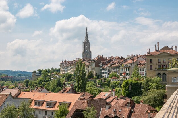 Panoramic view on Bern Minster and historic old town of Bern in Switzerland. Summer landscape, sunny day and blue sky