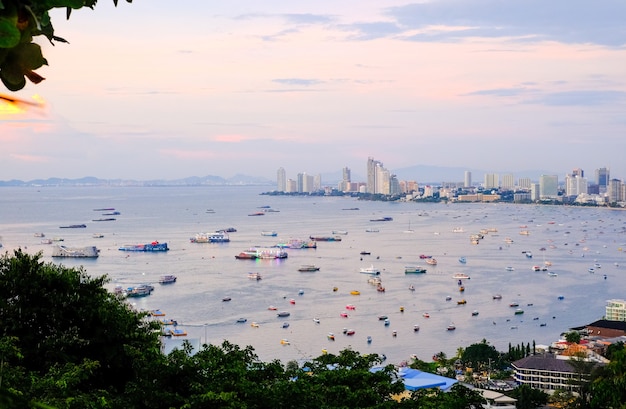 Panoramic view of the city and the bay with boats and yachts at sunset Pattaya city and the sea at dusk Thailand