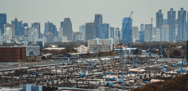 Panoramic view of cityscape and construction site in metropolis