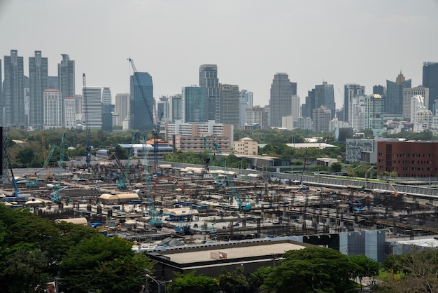 Panoramic view of cityscape and construction site in metropolis