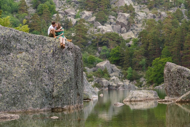 Panoramic view of couple sightseeing in a mountain in the black lagoon in Soria. Horizontal view of wanderlust couple hiking in nature landscape. People and travel destinations in Spain.