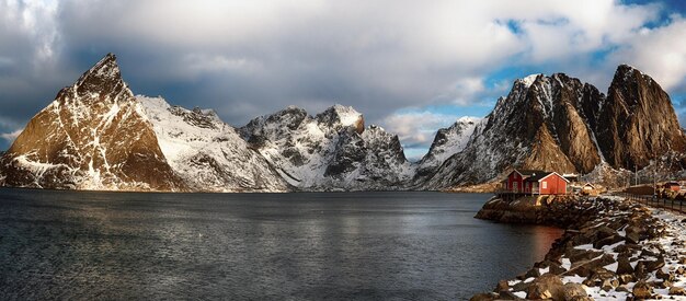 Panoramic view of the famous tourist attraction Hamnoy fishing village on Lofoten Islands, Norway with red rorbu house in winter