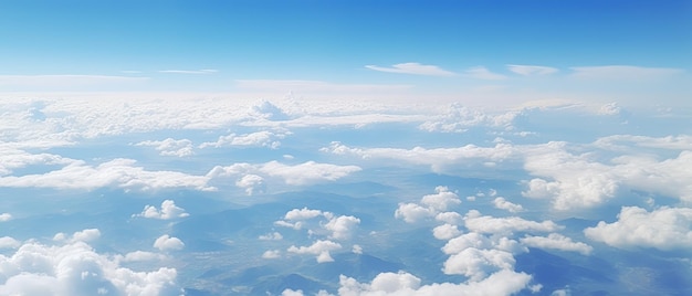 Panoramic view of fields and clouds from an airplane window The sky is a bright blue with fluffy white clouds