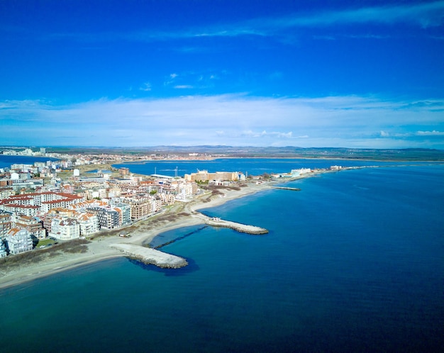 Panoramic view from a height above the town of Pomorie with houses and streets washed by the Black Sea in Bulgaria