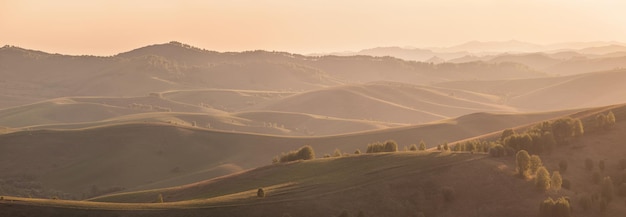 Panoramic view of the hills and mountain slopes in the sunset light