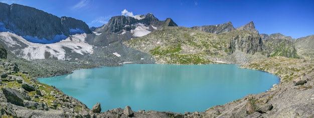 Panoramic view of the lake in the Altai mountains on a summer day