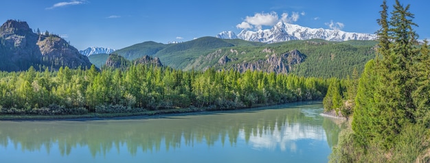 A panoramic view of the river with a calm flow in the Altai mountains