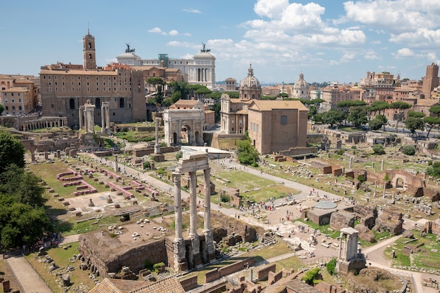 Panoramic view of Roman forum, also known by Forum Romanum or Foro Romano from Palatine Hill. It is a forum surrounded by ruins of ancient government buildings at center of city of Rome