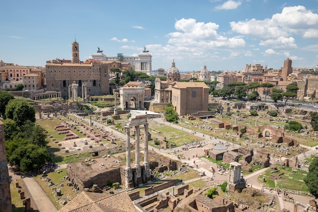 Panoramic view of Roman forum, also known by Forum Romanum or Foro Romano from Palatine Hill. It is a forum surrounded by ruins of ancient government buildings at center of city of Rome