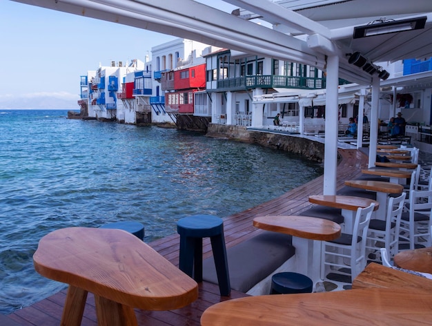 Panoramic view of the sights of the island of Little Venice with walking tourists in Mykonos Greece