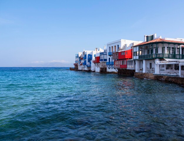 Panoramic view of the sights of the island of Little Venice with walking tourists in Mykonos Greece