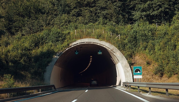 Panoramic view of tunnel entrance in Europe Landscape of highway road and mountain forest