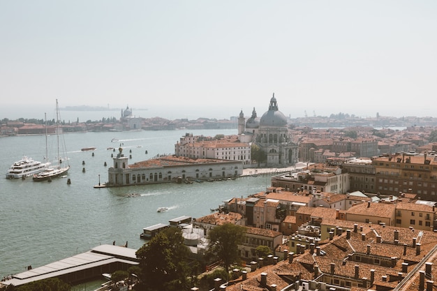 Panoramic view of Venice city and away Basilica di Santa Maria della Salute (Saint Mary of Healt) from St Mark's Campanile (Campanile di San Marco). Landscape of summer day and sunny blue sky