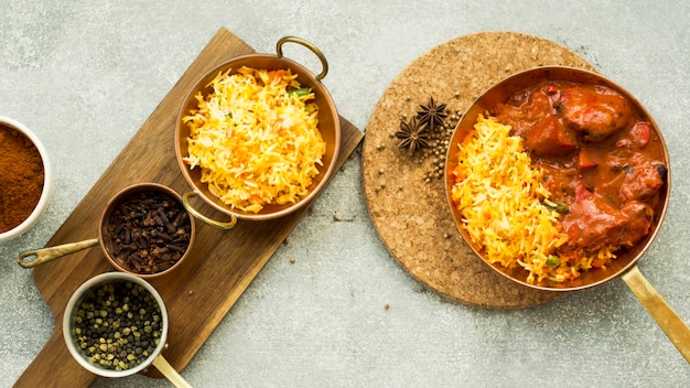 Pans with rice and spices on boards