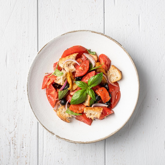 Panzanella salad in a white ceramic bowl top view