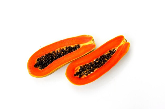 Papaya cuts isolated on white background with two pieces of delicious papaya in the middle of white