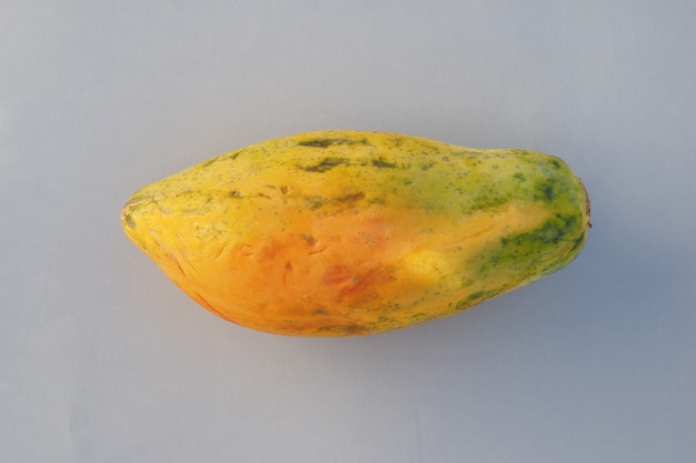 Papaya fruit on gray background.
