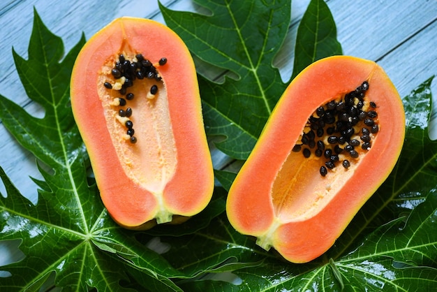 Papaya fruits on backgroud fresh ripe papaya slice tropical fruit with papaya seed and leaf leaves from papaya tree