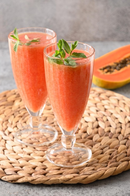 Papaya lassi in glass on black background