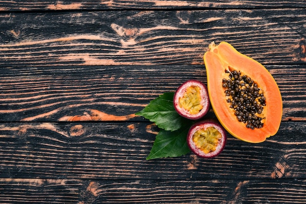 Papaya and maracuya Fresh Tropical Fruits On a wooden background Top view Copy space