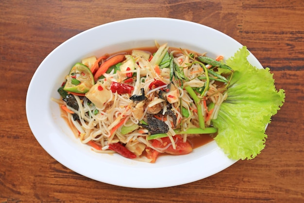 Papaya Salad Som Tam Pa the traditional Thai foods on wood table background Most wanted popular food in Thailand