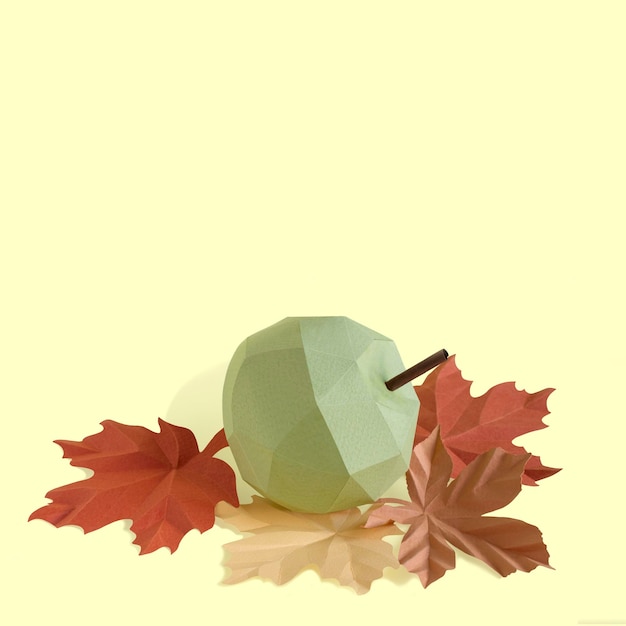 Paper apple and autumn leaves