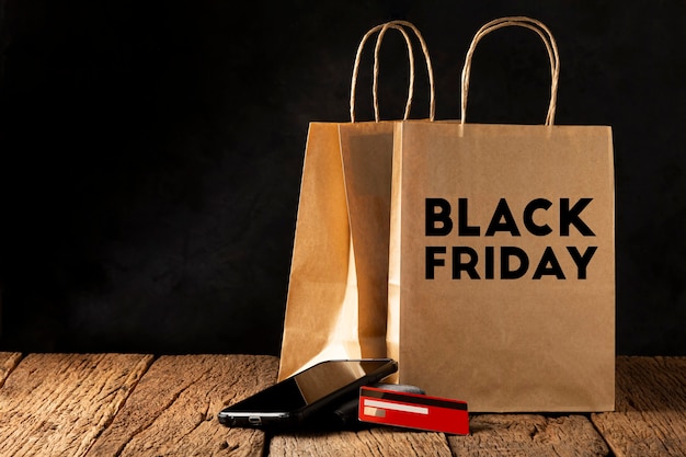 Paper bag, smartphone, wallet and credit card. Black Friday.