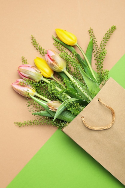 Paper bag with flowers on two tone background