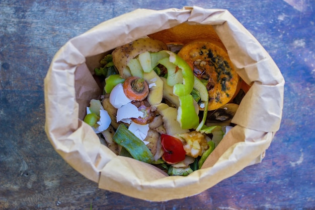 paper bag  with vegetables and other rubbish to make compost