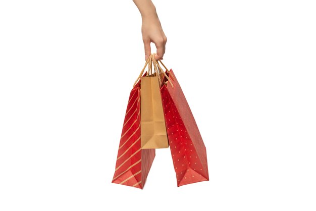 Paper bag in woman hands isolated on white background.