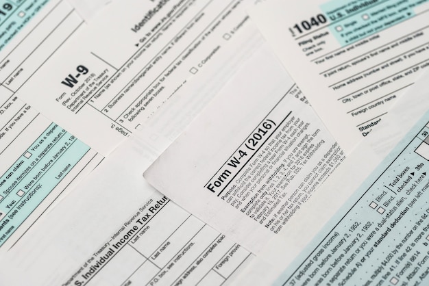 Paper blanks of 1040, w4 and w9 tax form close up