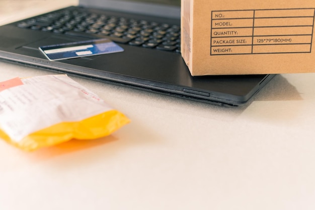 Paper boxes and credit card on the keyboard of a laptop online shopping concept