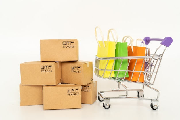 Paper boxes and a trolley on white background .Online shopping or ecommmerce concept and delivery service concept with copy space 